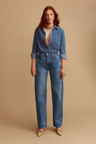 reformation winter sale woman wearing double denim jeand and shirt