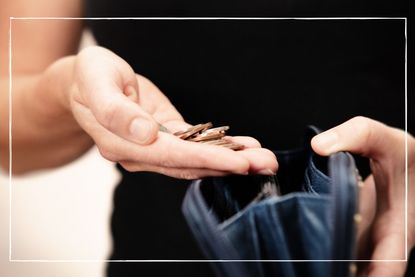 Close up of coins in woman's hand as she prepares to drop them into her purse