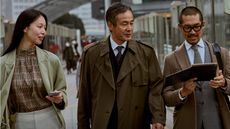 Whitepaper cover with image of three business colleagues walking outside in coats with one using a laptop