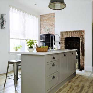 grey kitchen with fireplace and potted plant