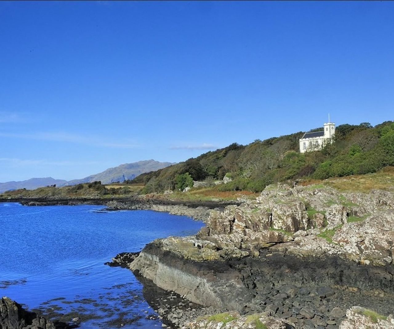 A plot with seaside views and a view of a nearby castle