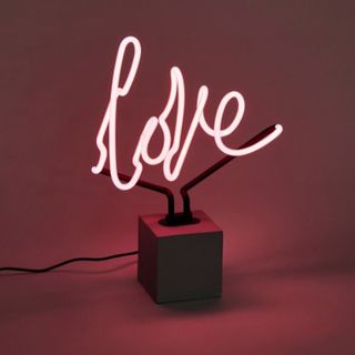 A neon sign that spells out the word love