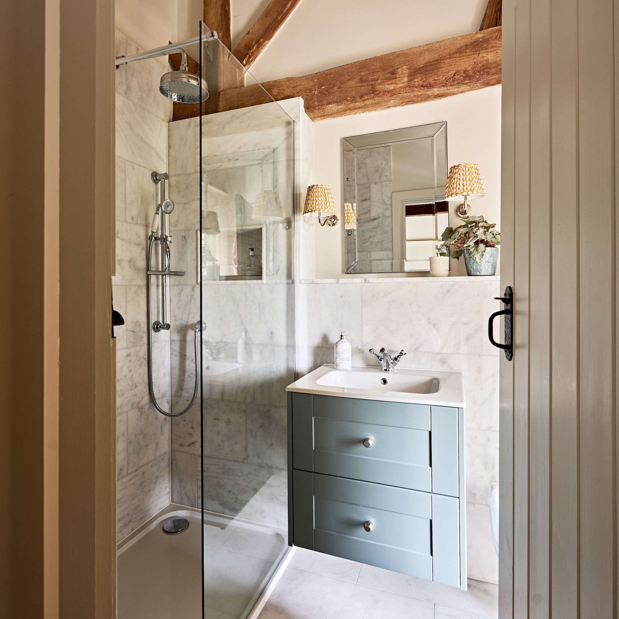bathroom with wall-hung vanity unit with basin and shower with glass screen door