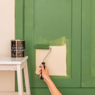 short nap roller with white stool and green paint