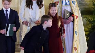 Prince Louis blows out Princess Charlotte's candle at the Together at Christmas carol concert