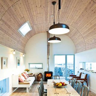 curved ceiling with whitewashed timber cladding