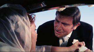 George Lazenby and Diana Rigg chatting on their wedding day in On Her Majesty's Secret Service.