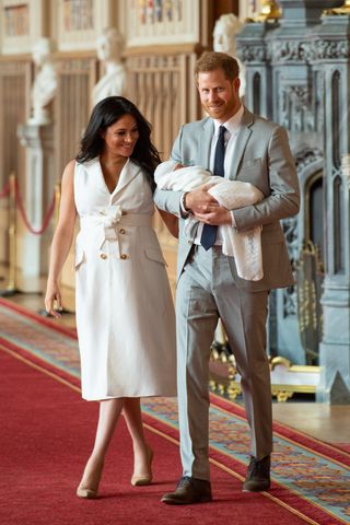 HRH Prince Harry, Duke of Sussex, and his wife Meghan, Duchess of Sussex, pose for a photo with their newborn baby son in St George's Hall at Windsor Castle on May 8, 2019. (Photo by Dominic Lipinski / AFP /Getty Images)