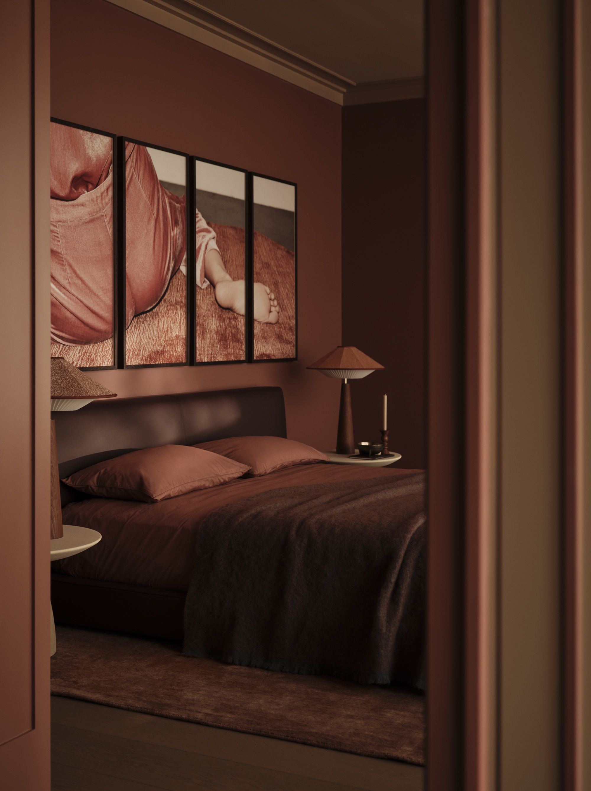 a dark red colordrenched bedroom with a red rug, upholstered bed and bed sheets. a wall art of a woman sat on a rug is on the walls