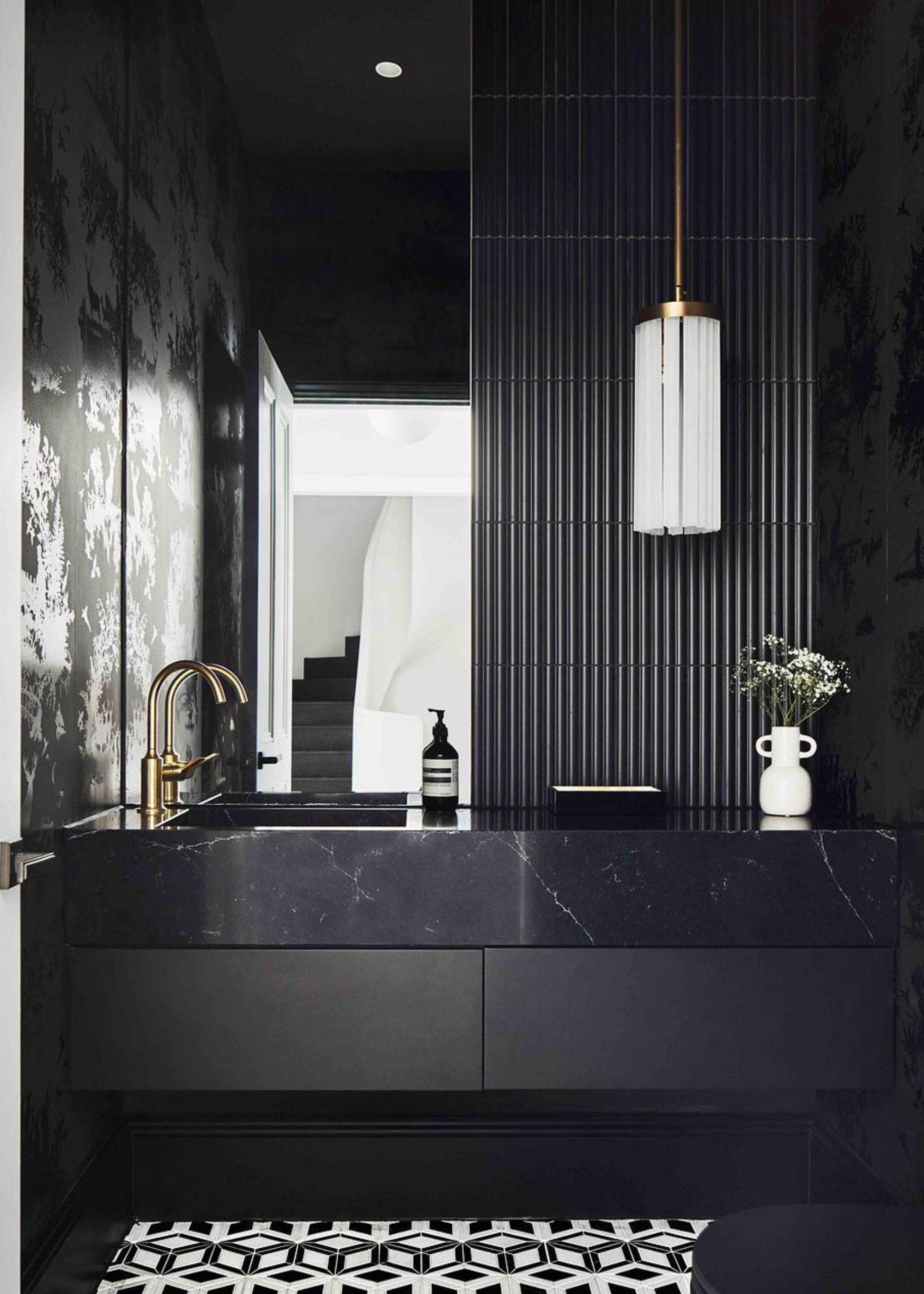 a small bathroom with a mirrored wall and a bathroom vanity with quartzite worktops