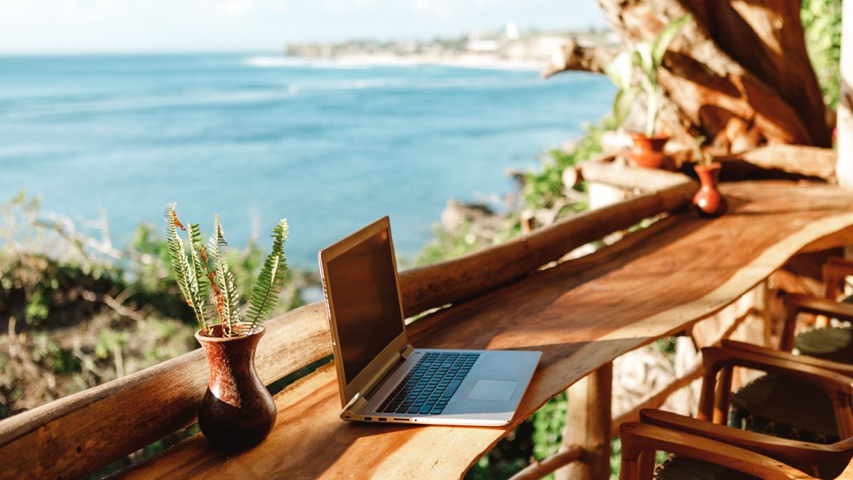 Laptop on table next to beach