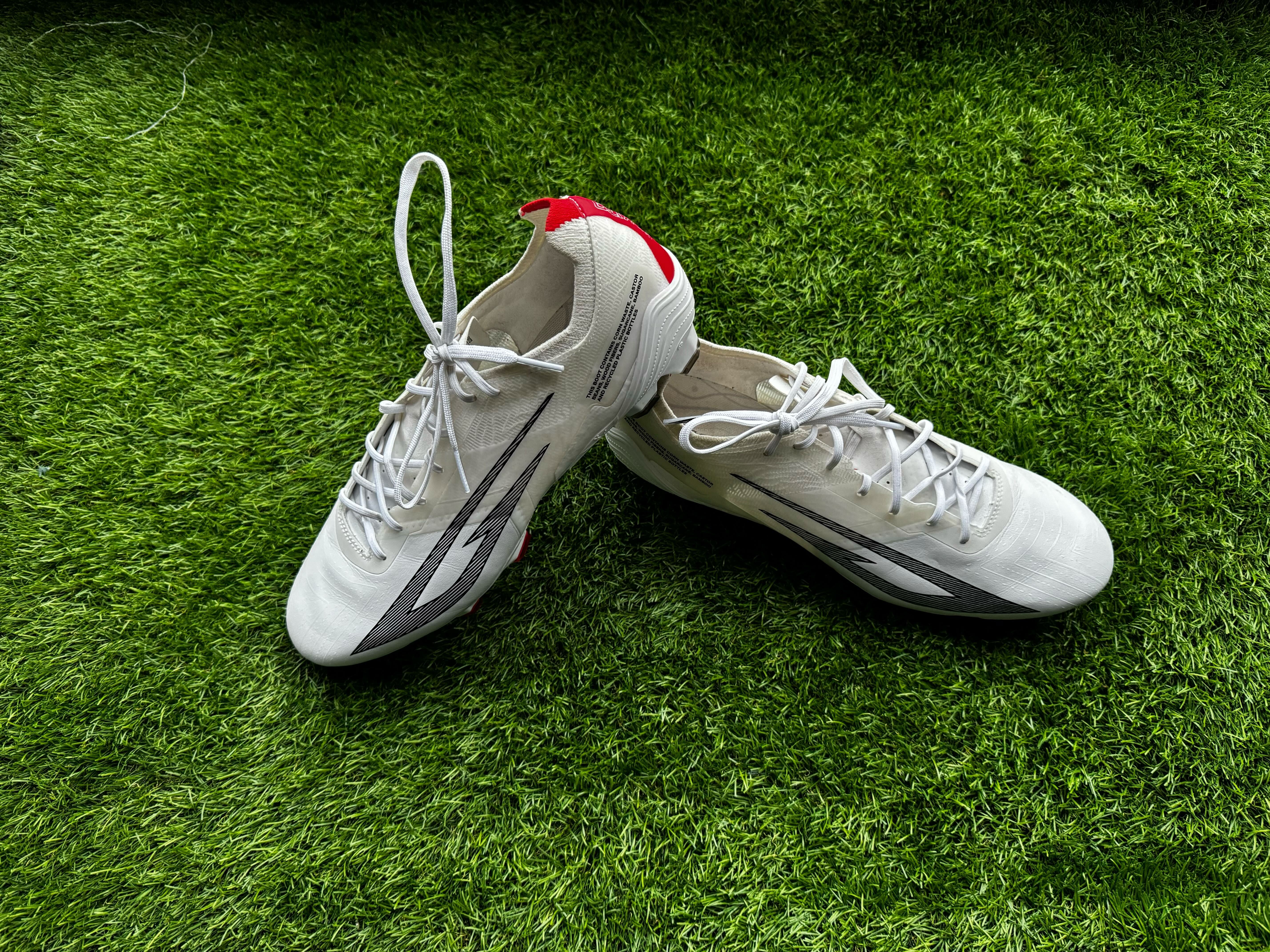 Sokito Scudetta football boots reviewed. The boots are placed on a piece of turf ahead of being reviewed.