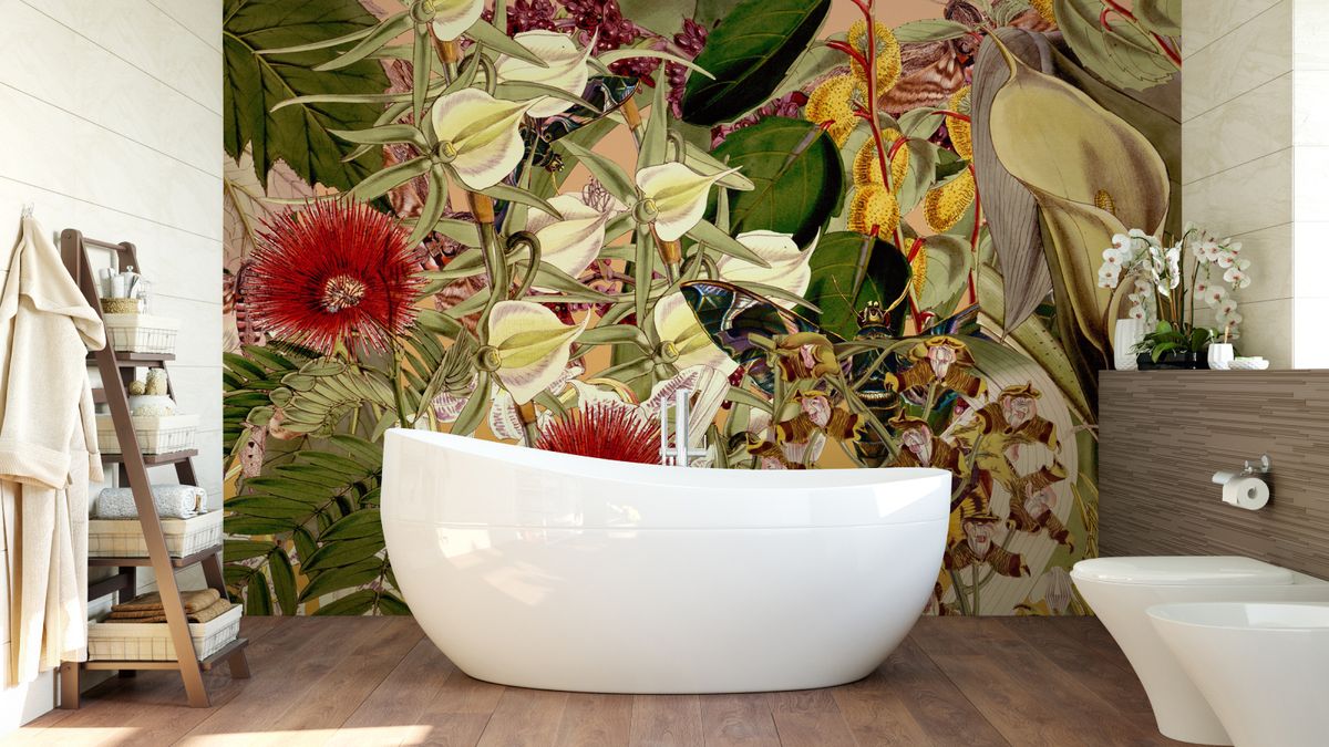 bold floral wallpaper mural in bathroom with wooden floor and white freestanding bath