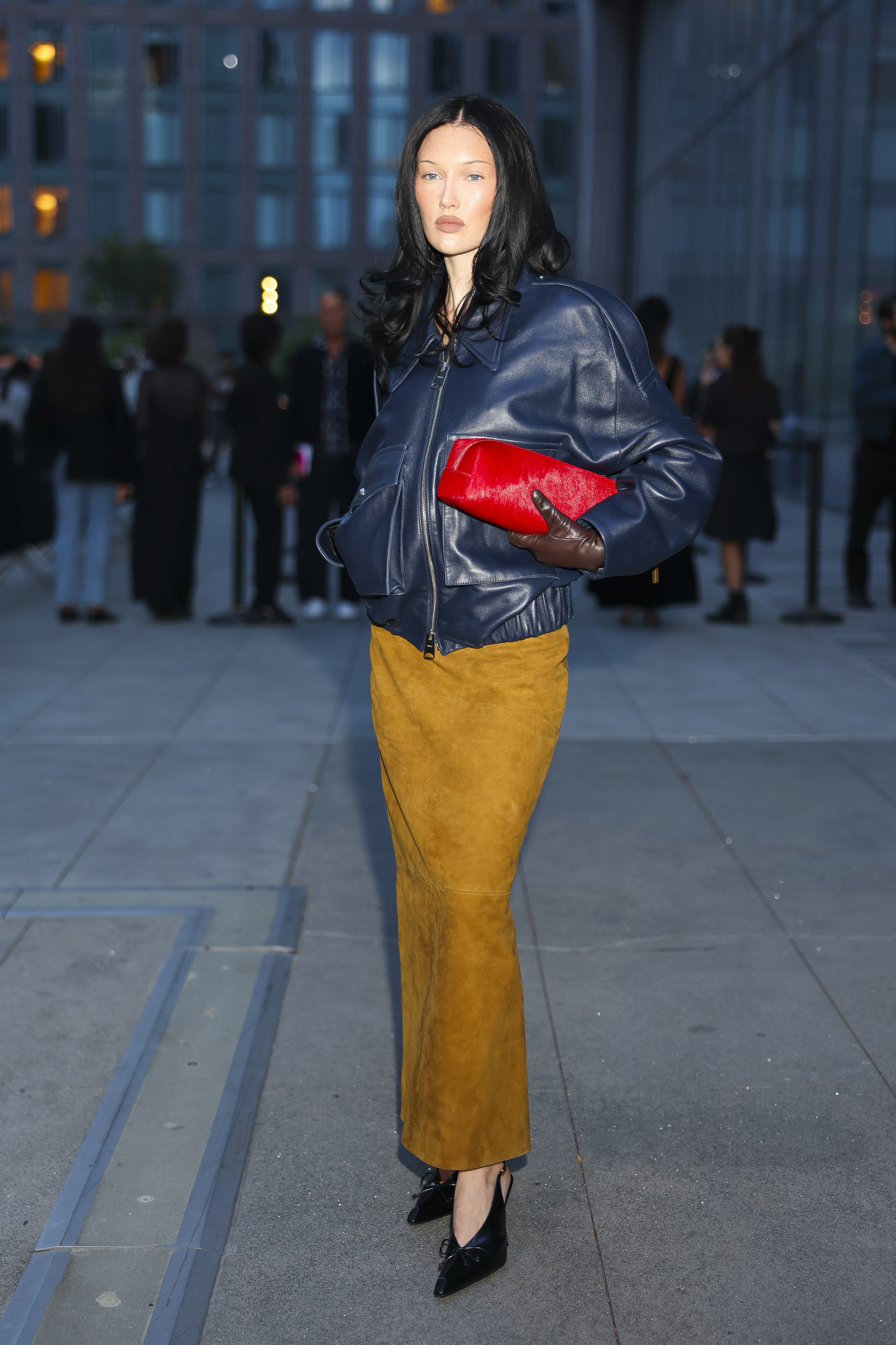 a woman wearing a brown suede skirt during fashion week