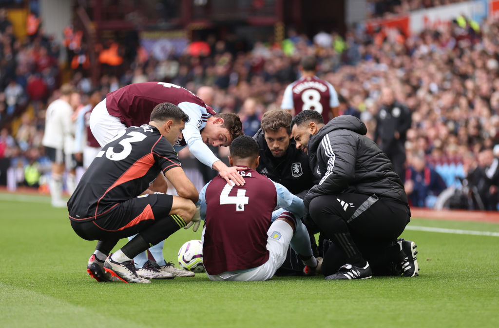 BIRMINGHAM, ENGLAND - OCTOBER 06: Team mates check on Ezri Konsa of Aston Villa as he is treated for an injury before being substituted during the Premier League match between Aston Villa FC and Manchester United FC at Villa Park on October 06, 2024 in Birmingham, England. (Photo by Catherine Ivill - AMA/Getty Images)