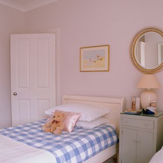 girl's bedroom with pink walls and bed