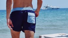 A man wearing shorts at the beach 