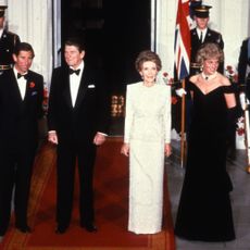 washington, dc november 09 prince charles, prince of wales l and diana, princess of wales r, wearing a midnight blue velvet, off the shoulder evening gown designed by victor edelstein, pose for a photograph with us president ronald reagan 2nd l and first lady nancy reagan 2nd r at the white house on november 9, 1985 in washington, dc photo by anwar husseingetty images