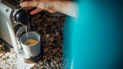 Male cyclist pouring a coffee