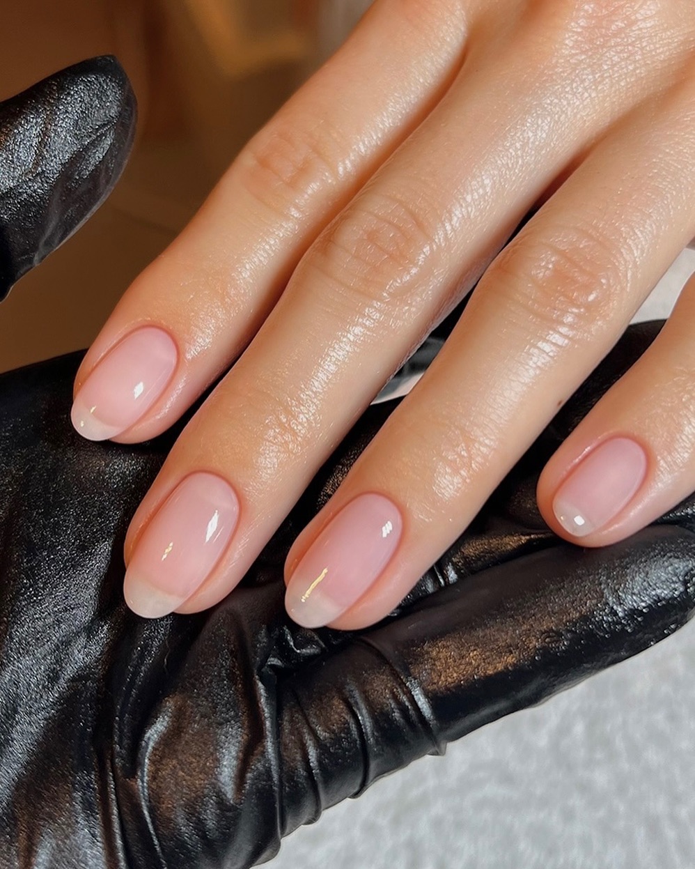 natural-looking nails painted with a sheer pink nail polish