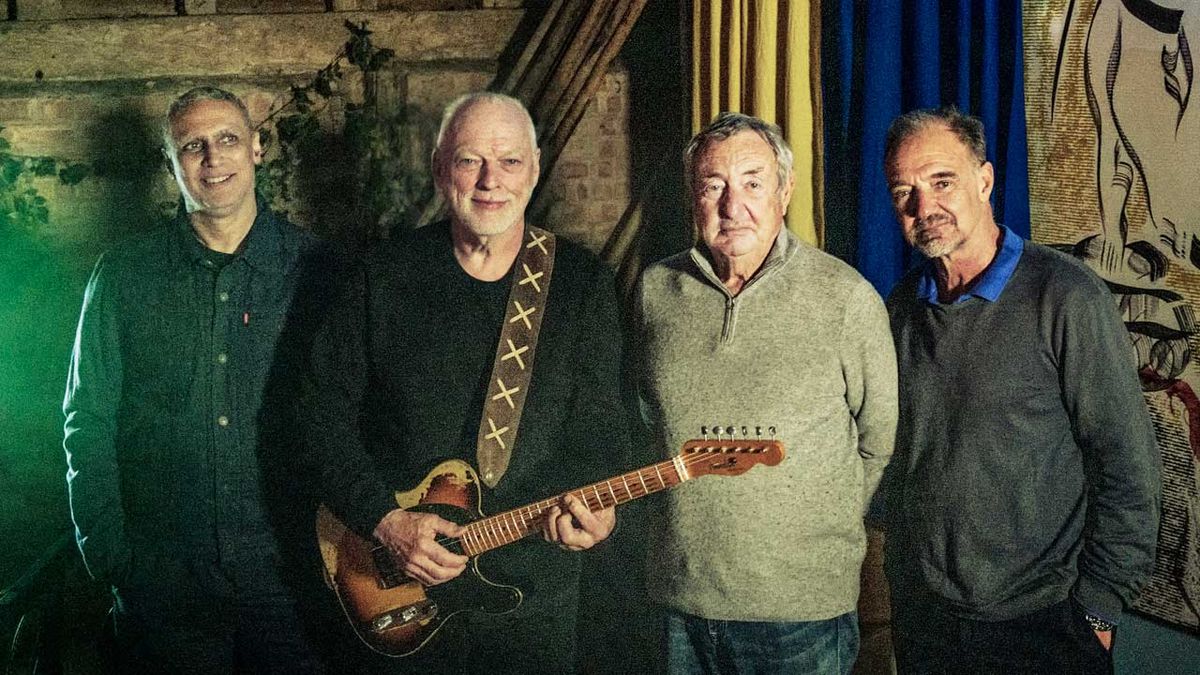 Pink Floyd standing in a barn 