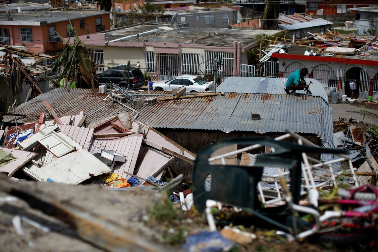 A man tries to rebuild his house after Hurricane Maria in Canovanas, Puerto Rico.