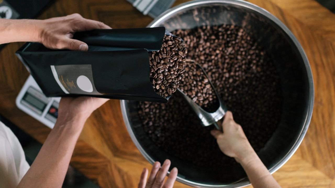 coffee prices People working in Roastery Filling package - stock photo 