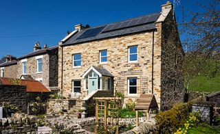 solar panels on roof of stone clad self build
