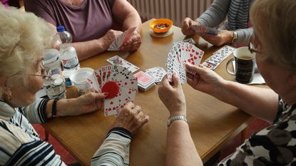 Elderly people playing bridge