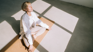 Woman meditating on mat