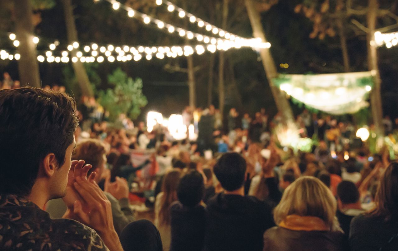 A folky rock concert outdoors in the evening