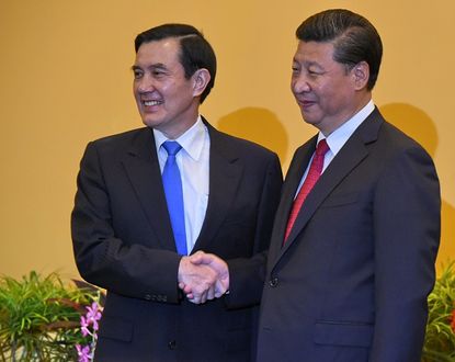 Taiwan President Ma Ying-jeou and Chinese President Xi Jinping shake hands.
