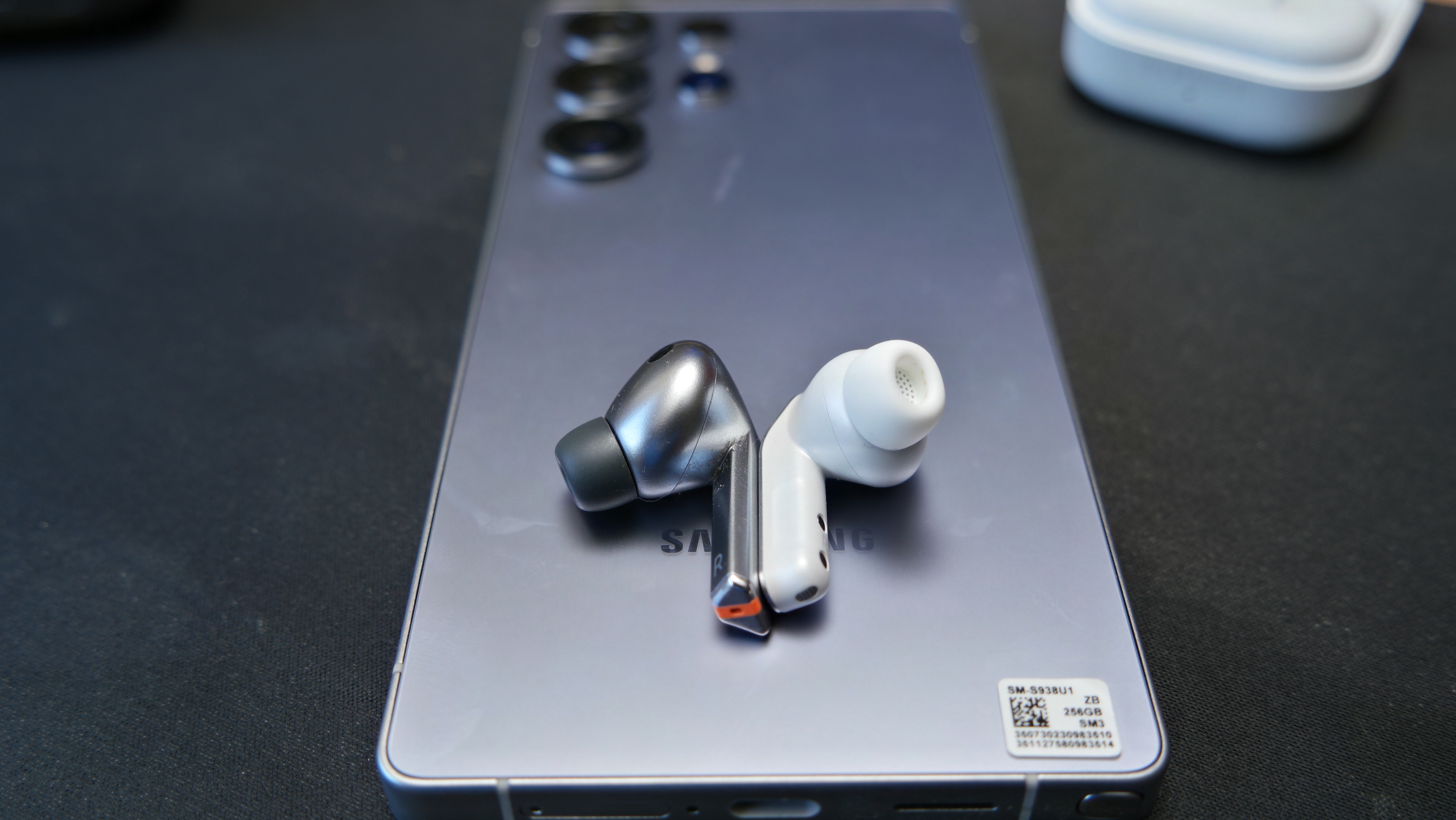 Galaxy Buds 4 Pro on a desk, next to Galaxy Buds3 Pro