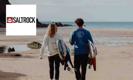saltrock logo top left with two people holding surfboards on the beach