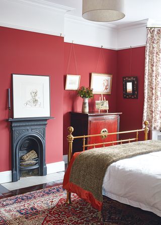 Guest bedroom with reclaimed fireplace in a Victorian house