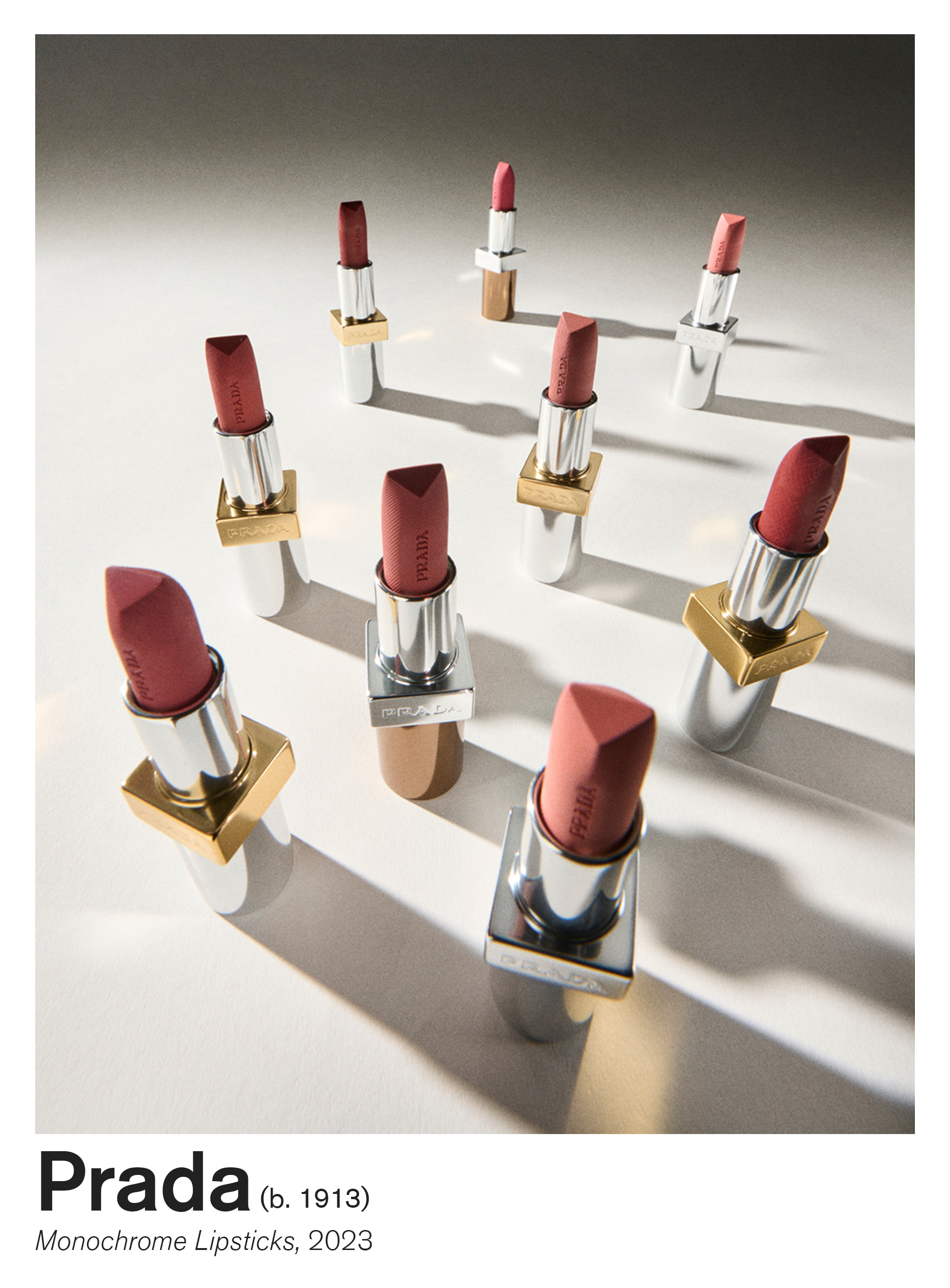 Nine Prada Monochrome lipsticks shot with their lids off in an array of pink and red shades