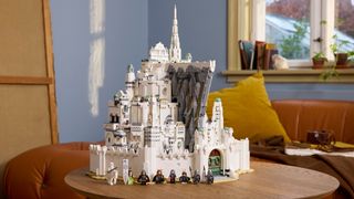 Lego Minas Tirith on a wooden surface, with multiple minifigures visible 