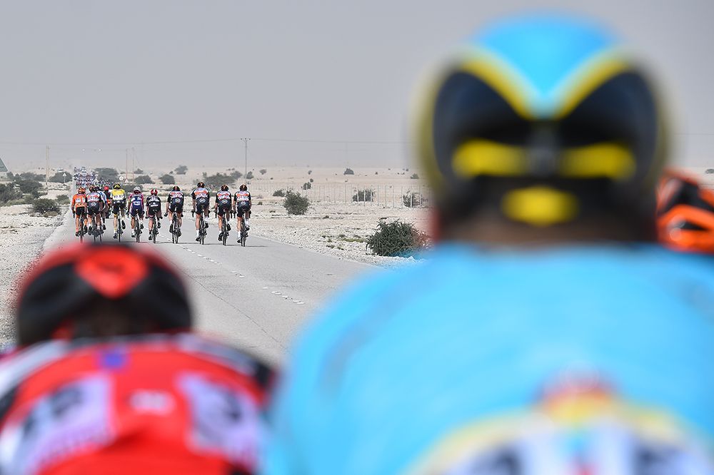 The peloton watch the leading group escape up the road