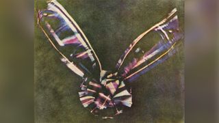 A photo taken in 1861 of a color tartan-pattern ribbon tied in a bow