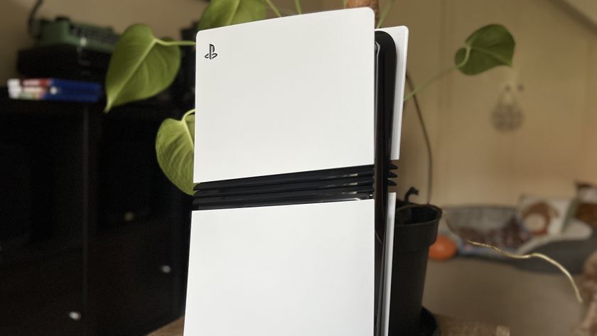 Top section of a PS5 Pro console in front of a houseplant
