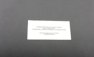 Thom Browne's simple bookmark invitation.