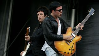 Musicians Johnny Marr (L) and Ryan Jarman of The Cribs perform during the 2010 Lollapalooza festival in Grant Park on August 8, 2010 in Chicago, Illinois