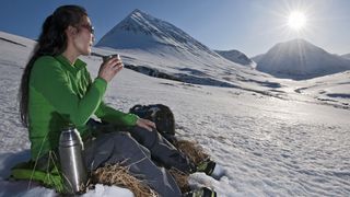 how to clean a flask: woman drinking in Iceland