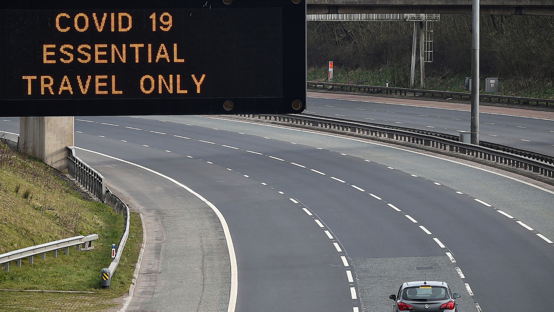 A lone car driving on an empty road