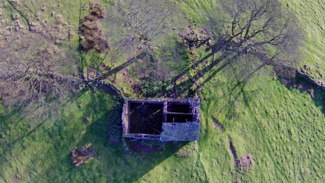Holy Stone HS700E example shot_overhead view of abandon cottage in field