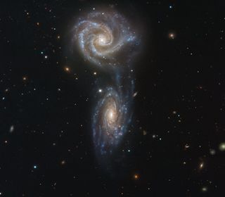 Two spiral galaxies collectively known as Arp 271 look like they're getting ready to collide. The two interacting galaxies, NGC 5426 and NGC 5427, have formed a bridge of material where new stars are beginning to form. If the galaxies do end up crashing into each other, the collision will trigger a wave of new star formation over the next few million years, according to the European Southern Observatory (ESO). This same type of interaction may happen to our own Milky Way galaxy when it collides with the Andromeda galaxy in the next five billion years or so, ESO said.