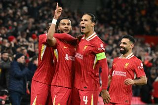 Cody Gakpo (2L) celebrates scoring the team's second goal with Liverpool's Dutch defender #04 Virgil van Dijk during the UEFA Champions League football match between Liverpool and Real Madrid at Anfield in Liverpool, north west England on November 27, 2024. 