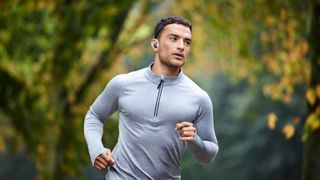 a man running while wearing the jabra elite 4 active true wireless earbuds