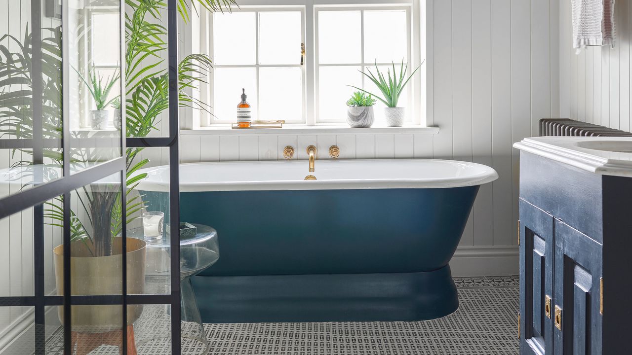 Blue freestanding bath in blue bathroom