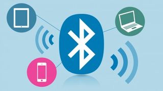 Bluetooth symbol reaching out to laptop, cellphone and tablet